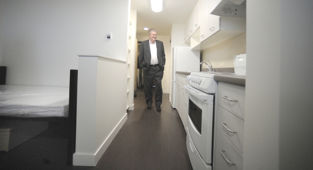 Rich Coleman, minister of natural gas development and housing, tours the Budzey Building, a newly completed structure providing 147 apartments for women or women with kids who are homeless or at risk of homelessness, in Vancouver on Thursday. Photograph by: NICK PROCAYLO , PNG
